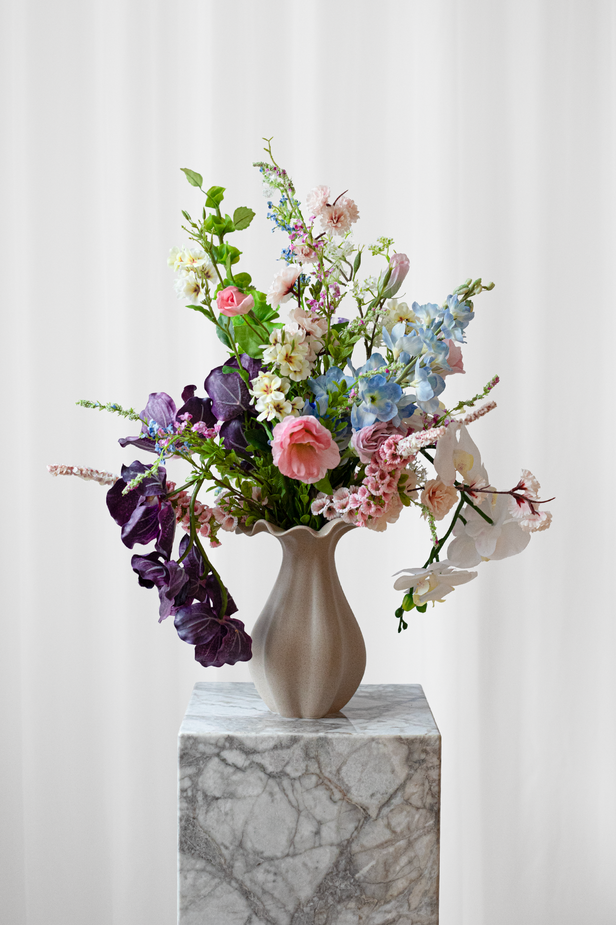 Buket af kunstige blomster med naturtro udseende. Buketten er luftig og inspireret af markens blomster i skønne, farverige nuancer.