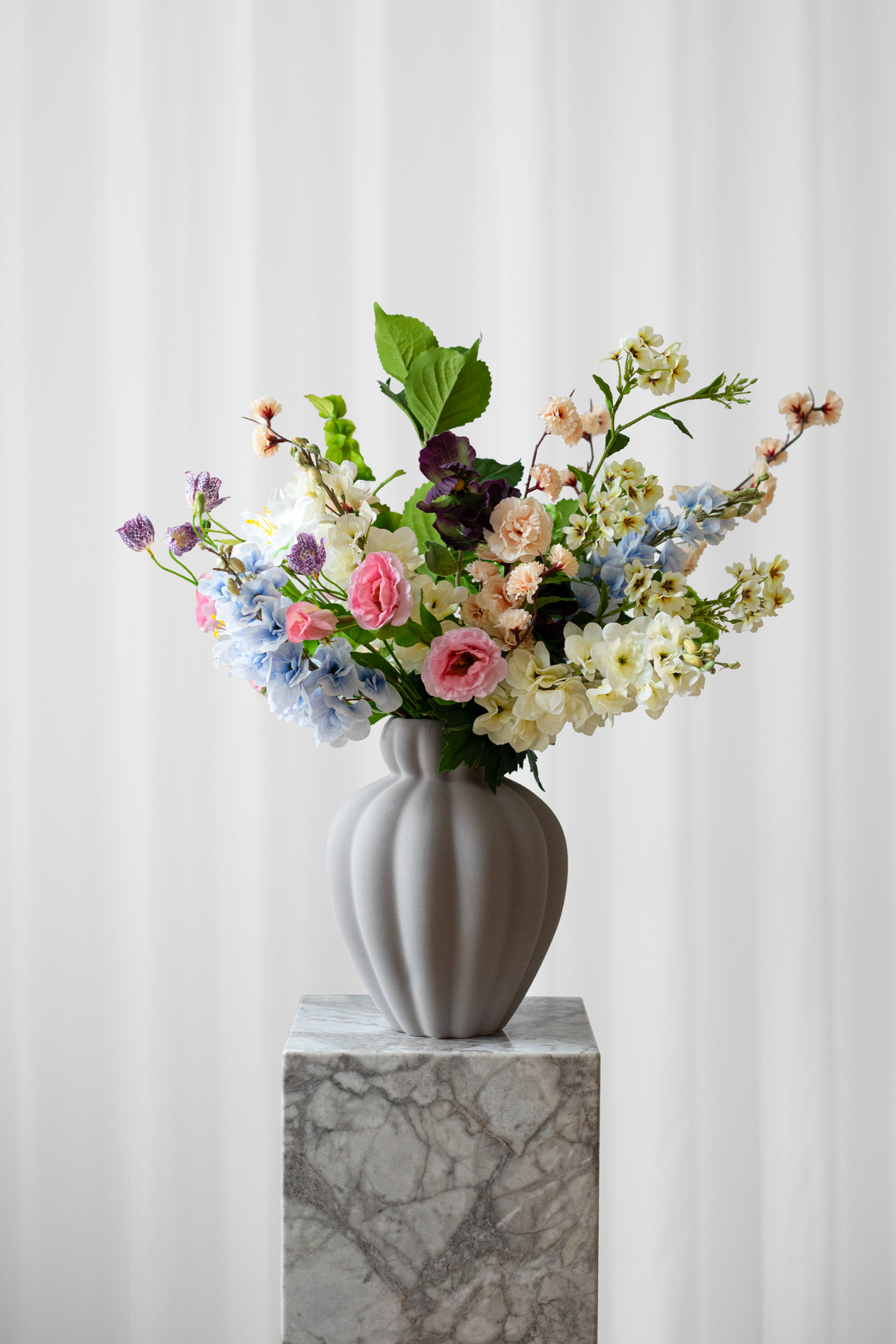 Kunstig buket fra Specktrum i farveige nuancer. Blomsterne er naturtro.