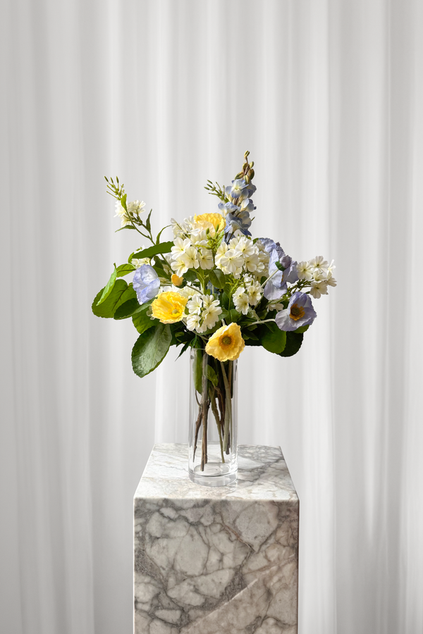 Sommerlig buket buket af kunstige blomster i gule og blå farver. 