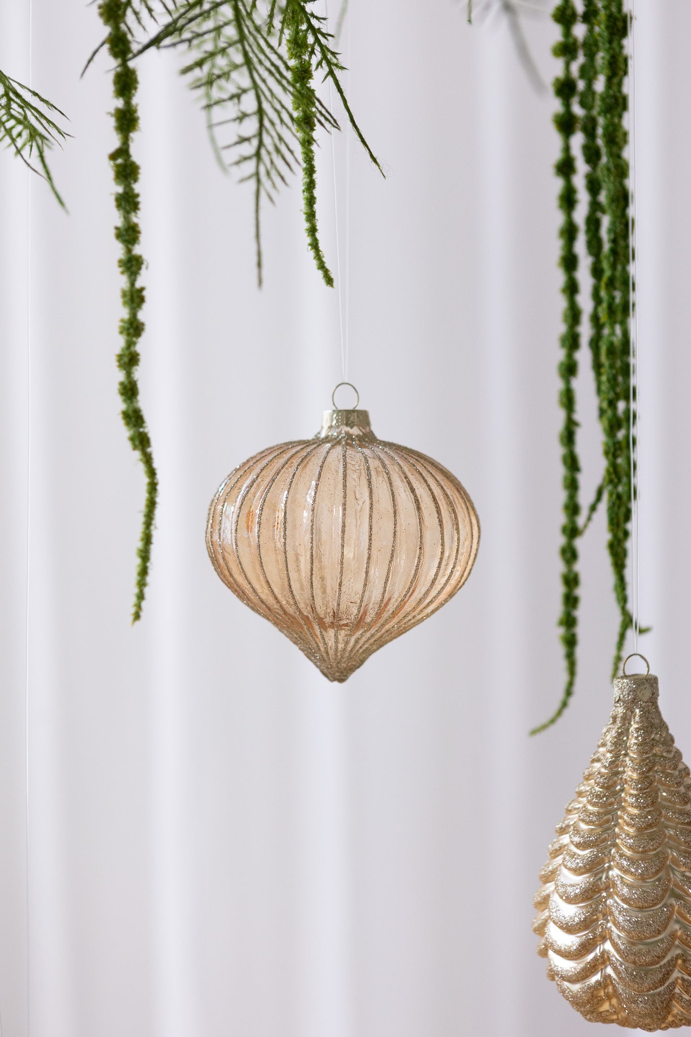 Nærbillede af Dråbeformet glasjulekugle i orange med glimmer